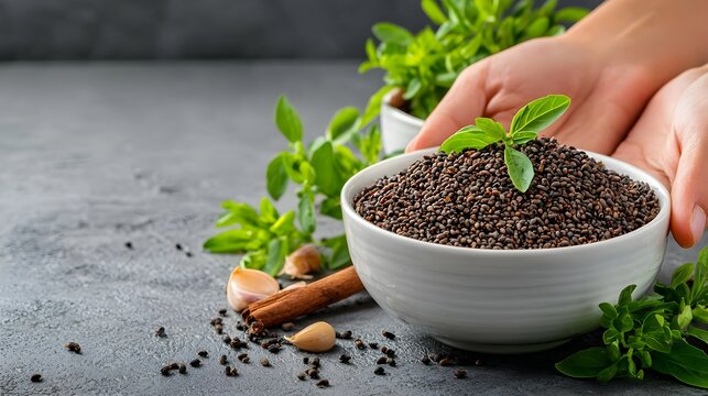 Whole and crushed black cumin seeds also known as nigella seeds displayed on a plain white background