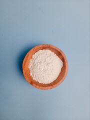 Overhead view of flour served in a wooden bowl