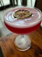 Reddish pink cocktail in a vintage glass