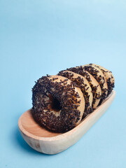 Chocolate donuts with messes on blue background