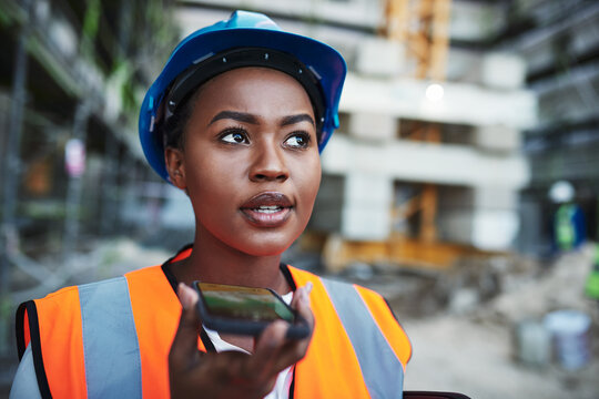 Black woman, builder or architect with speaker phone at site for communication or construction. Young African, civil engineer or safety worker on mobile smartphone for radio or voice note in city