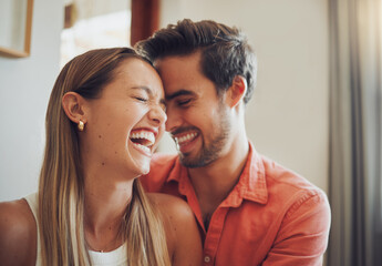 Love, laugh and happy couple touch forehead in home for care, connection or talk together. Living room, man and woman with funny joke, comedy or communication for romantic relationship with partner