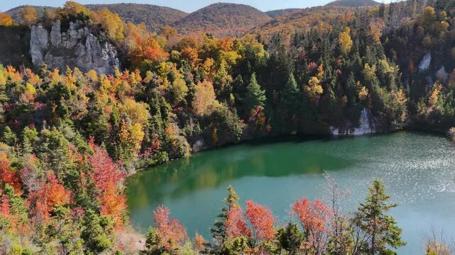Aerial view of Gypsum Lake in Cape Breton Nova Scotia during Autumn.  Fall foliage of the mountains with multi colored deciduous trees, La Prairie, Cabot Trail, Cape Breton. 