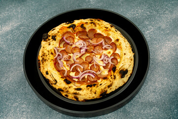 Traditional rustic artisanal pepperoni and onion pizza. Calabresa sausage pizza