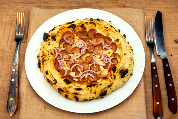 Traditional rustic artisanal pepperoni and onion pizza. Calabresa sausage pizza