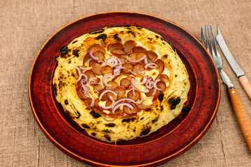 Traditional rustic artisanal pepperoni and onion pizza. Calabresa sausage pizza