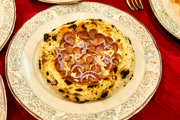 Traditional rustic artisanal pepperoni and onion pizza. Calabresa sausage pizza