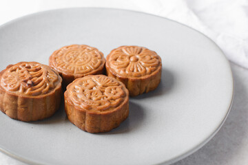 Overhead view of homemade mooncakes, top view of baked mooncakes on grey plate, process of making mooncakes for Lunar New Year and mid autumn festival