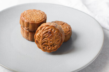 Overhead view of homemade mooncakes, top view of baked mooncakes on grey plate, process of making mooncakes for Lunar New Year and mid autumn festival