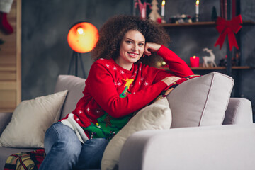 Photo of adorable nice woman wear new year print sweater sit couch relax rest christmas weekend time indoors