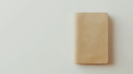 A simple, textured notebook lies flat on a light surface, showcasing a minimalist design and a neutral color palette.