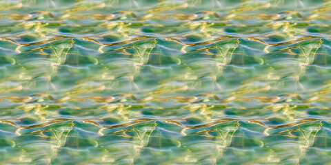 Seamless Pattern Texture Background: A close-up of greenish-blue water, softly illuminated by sunlight, with visible caustic effects