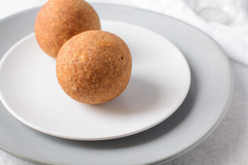 homemade nigerian egg roll in a white ceramic plate, freshly made african egg roll on a white plate, egg wrapped in fried dough