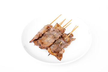Set Grilled pork on bamboo skewers The Thai name is moo ping on a white plate isolated on background. Simple food in morning rush hour. Thai street food that is available everywhere.