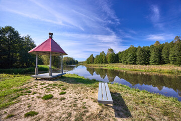 Tranquil Waterfront Gazebo on Sunny Day