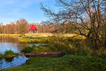 Tranquil Lakeside Gazebo with Red Roof in Autumn