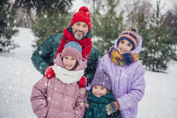 Photo of cheerful charming husband wife small kids wear windbreakers enjoying snowy weather together outside urban city park