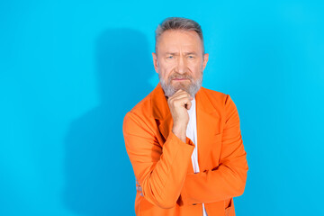 Photo of funny trendy aged man hand touch chin think empty space wear orange costume isolated on...
