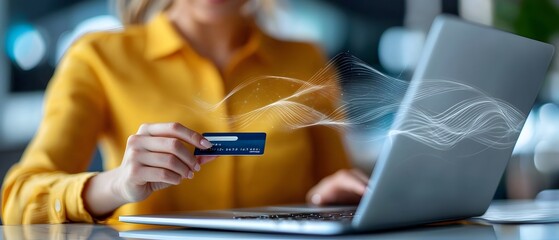 Portrait of a young woman confirming an online order on her laptop computer while holding a credit card representing the successful completion of an ecommerce transaction