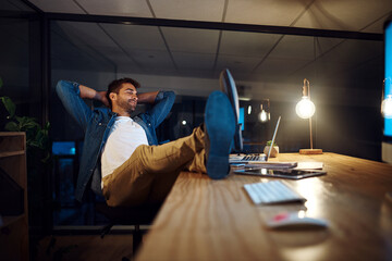 Businessman, laptop and relax for project management, networking and communication in office at...