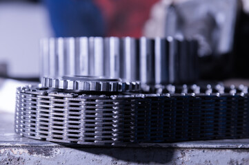 Uninstalled transfer case gear with wide torque chain. Tinted repair image