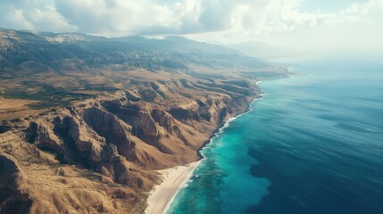 Fototapeta premium A breathtaking aerial view of Socotra Island, showcasing its unique landscape with dramatic cliffs, sandy beaches, and diverse vegetation. No people included.