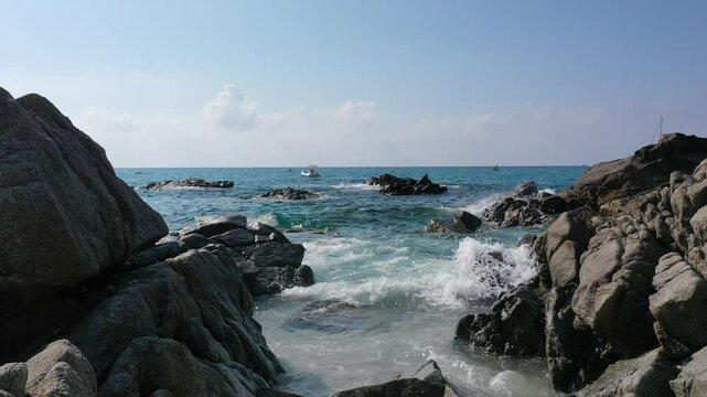 Aerial view of sea and rocky beach in Marinella Di Zambrone on a sunny summer day in Calabria, Italy