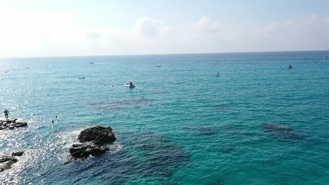 Aerial view of sea and rocky beach in Marinella Di Zambrone on a sunny summer day in Calabria, Italy