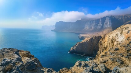 Panoramic shot of the dramatic cliffs along the coast of Socotra Island, showcasing the rugged terrain and vast ocean views. No people included.