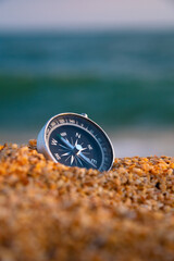 Conceptual photo of a compass in a deserted uninhabited area. Compass lying on the seashore, stability and peace © yanik88