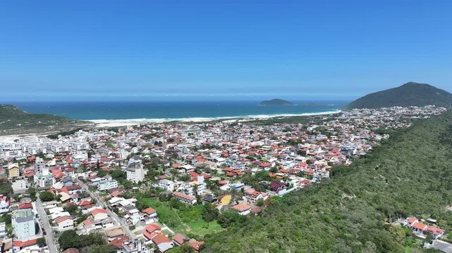 Santinho Beach At Florianopolis Santa Catarina Brazil. Turquoise Ocean Waves Gently Crashing On Tropical Beach. Shore Sky Clouds Beach Sea. Seaside Panning Wide. Florianopolis Santa Catarina.