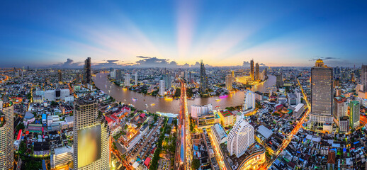 Naklejka premium Aerial view of traffic and transportation during rush hour on expressway and skyscrapers over financial district in downtown Bangkok, Thailand. Asia tourist attraction. City skyline. 