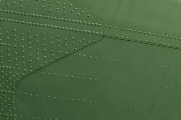 Metal plating of military equipment with rivets.