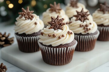 Delicious christmas chocolate cupcakes with vanilla frosting and sprinkles sitting on white marble tray