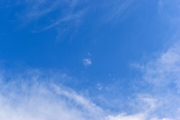 beautiful blue sky and white fluffy group of clouds with sunrise in the morning, natural background