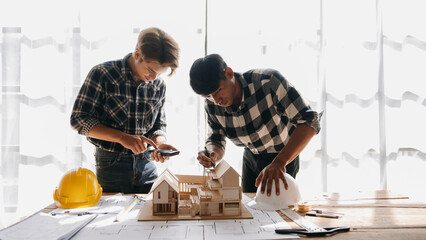 Three architects discussing new project. young men and women working together to form a new building.