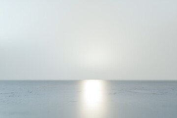 Obraz premium A minimalist scene featuring soft light reflecting on a smooth surface, creating a tranquil and serene atmosphere.