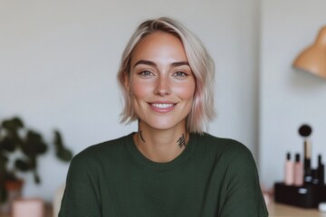 Smiling young woman with dyed hair and tattoos looking at camera