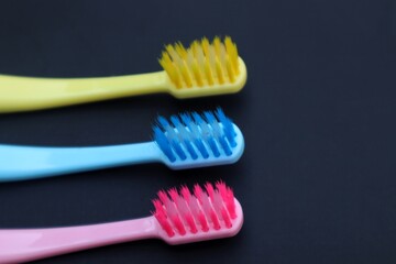 Toothbrush isolated on dark background, close up view.