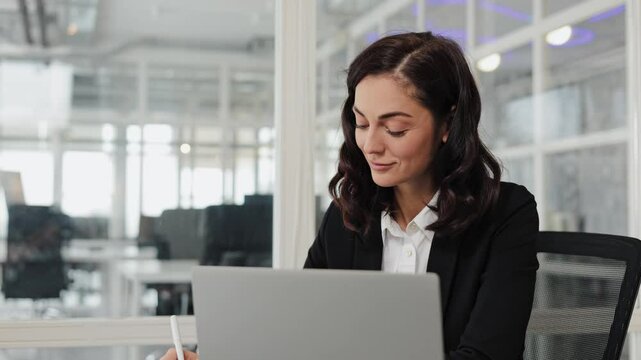 Busy 30 years old business woman entrepreneur working in office checking documents in office. Businesswoman account female manager executive or lawyer using laptop computer at work.