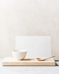Minimalist table setting with a white bowl and wooden spoon on a wooden surface