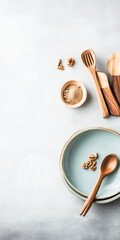 Wooden utensils and ingredients arranged on a gray surface for food preparation