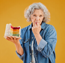 Birthday, cake and portrait of mature woman in studio isolated on yellow background for party....
