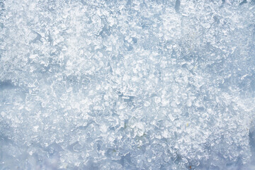 close-up of ice and frost in freezer tray with cold blue tones