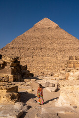 Girl posing in front of the pyramids of Giza in Egypt