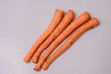 Fresh carrots displayed against a clean white background, highlighting their vibrant orange color and crisp texture