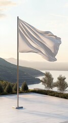 A flag mockup flutters on a pole, with rolling hills and a calm sea in the background