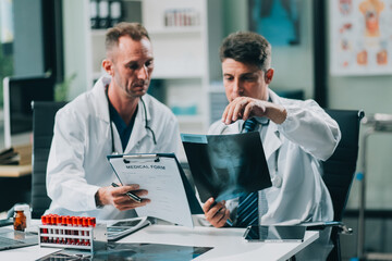 Group of medical practitioners working together and analyzing medical scan in the hospital