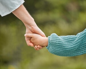 Parent, kid and holding hands with care in nature for bonding, safety or protection at park....