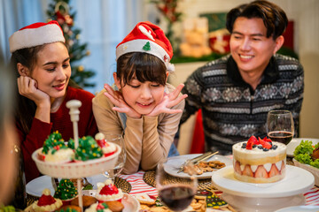 Asian lovely family celebrating Christmas party together in house. 